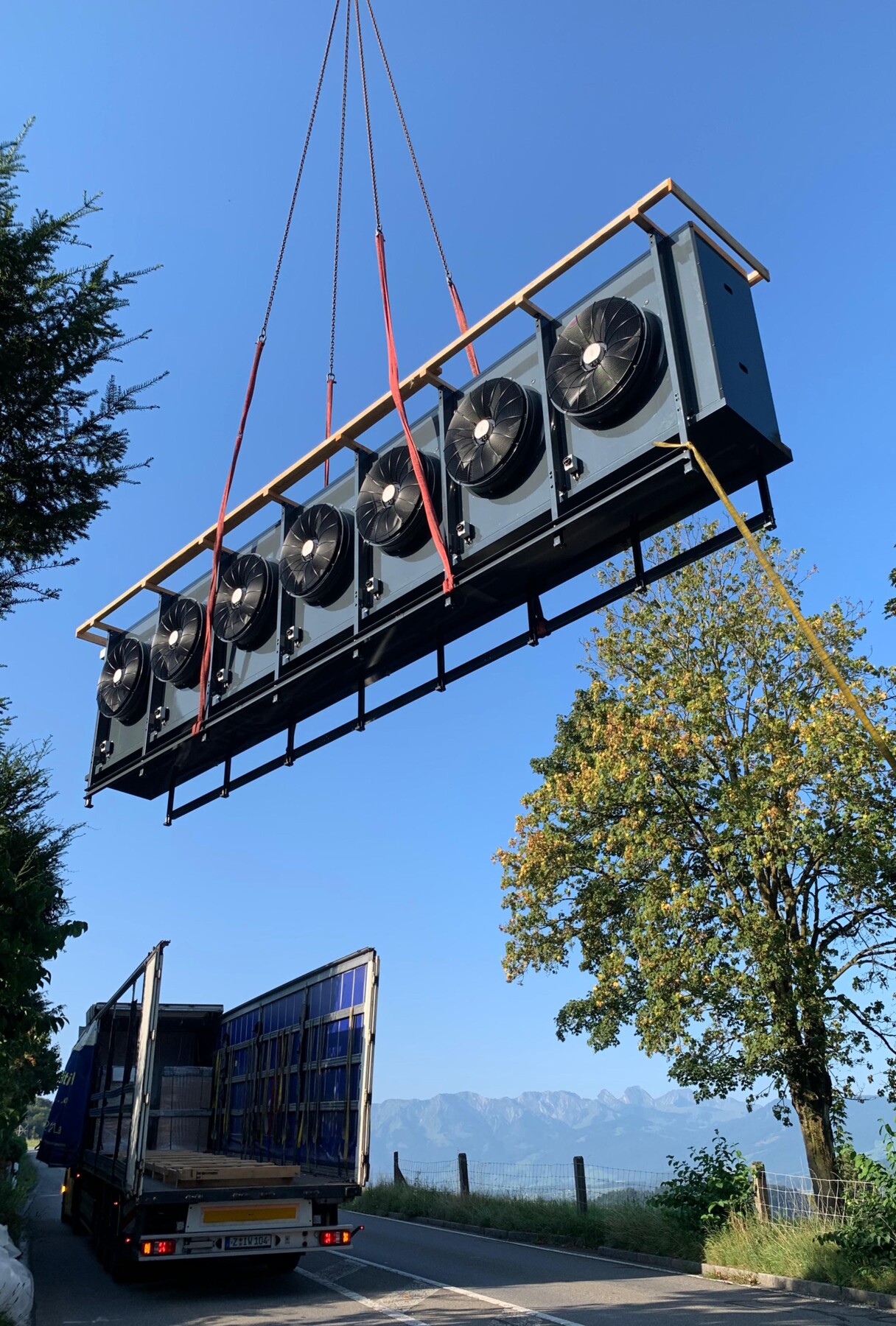 Montage des Luftkühlers der CO₂-Split-Wärmepumpe per Kran bei der Wohnüberbauung in Oberdiessbach