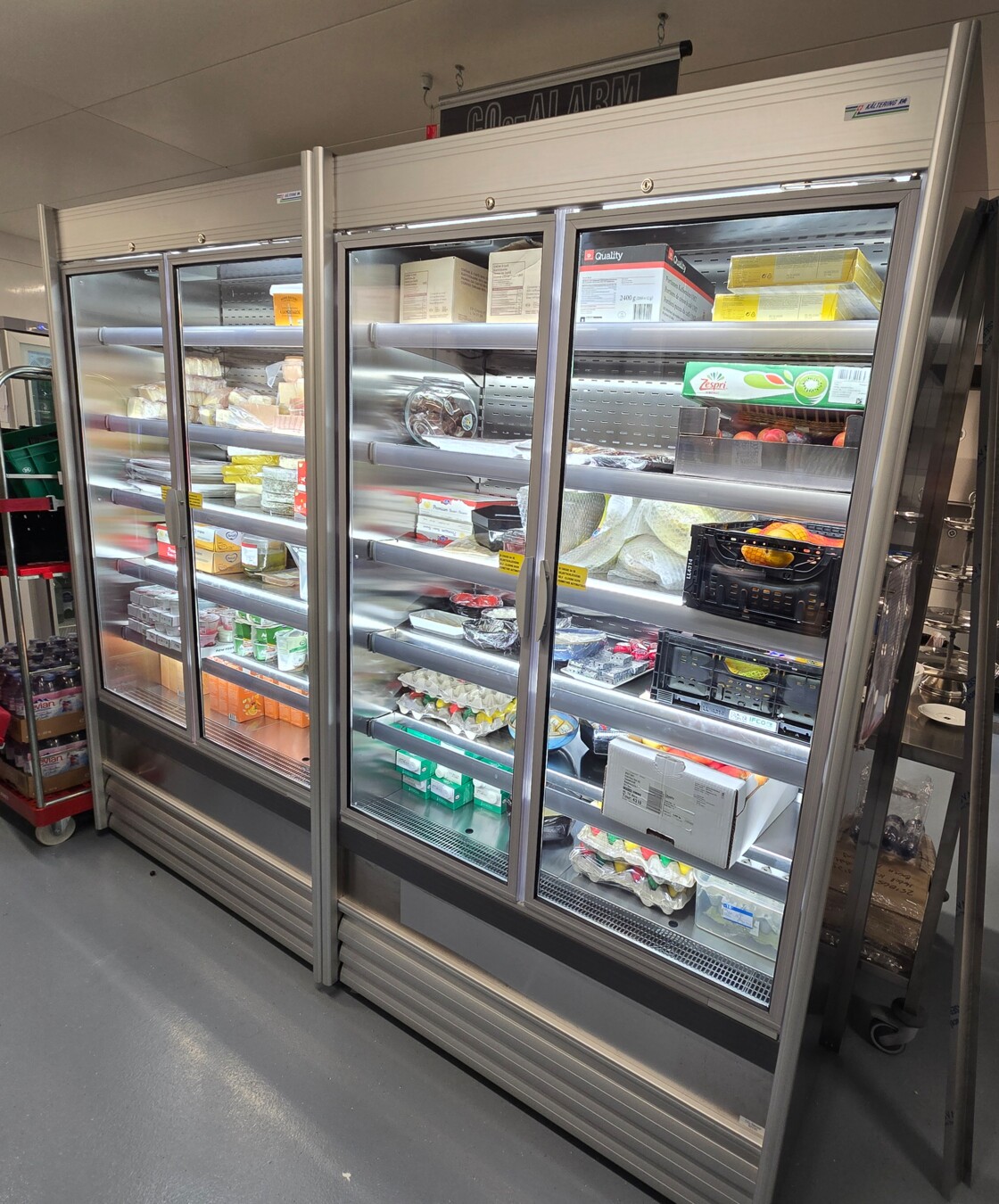 Gekühltes Verkaufsregal mit verglasten Türen für die Präsentation und Lagerung von Lebensmitteln und Getränken.